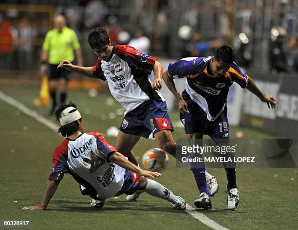 Jose Garcia and Allan Zamora , from Mexican team Atlante, fight for the ball against Jairo Arrieta , from Costarican team Saprissa on March 20 at...