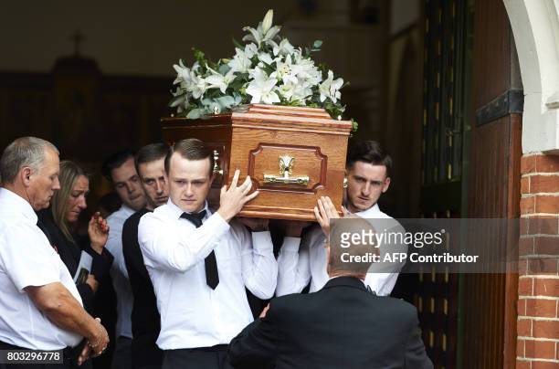 Pallbearers carry the coffin of Grenfell tower fire victim Anthony Disson during the funeral service in North Kensington on June 29, 2017. / AFP...