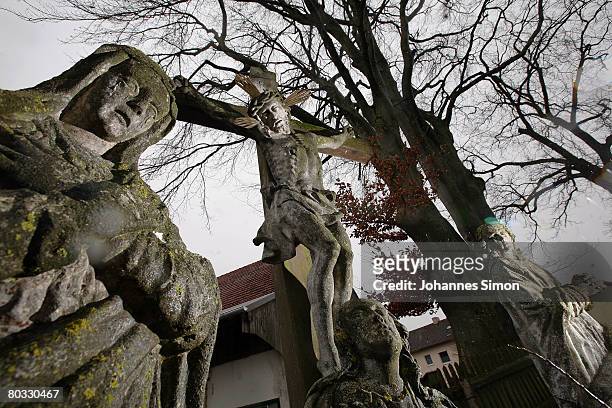 Lifesize depiction of Christ on the cross with St. Mary is seen at 17th century Calvary during Good Friday under a cloudy, snowy sky on March 21,...