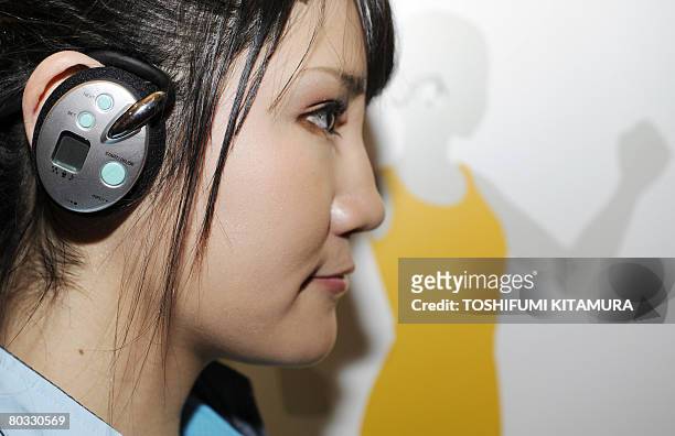 Model displays Sega Toys' "Karada Trainer " during its press preview in Tokyo on Feburary 26, 2008. The "Karada Trainer is a mobile "private...