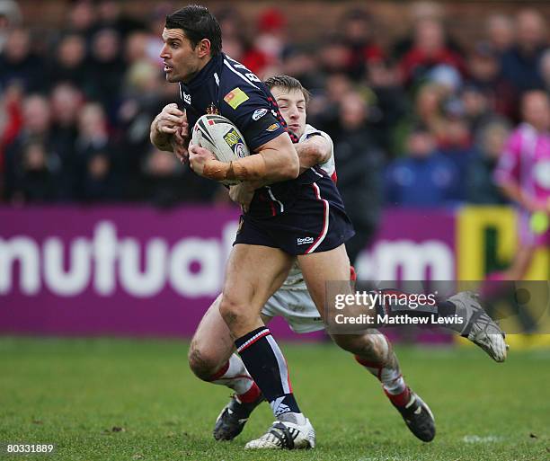 Trent Barrett of Wigan is tackled by James Roby of St.Helens during the engage Super League match between St. Helens and And Wigan Warriors at...