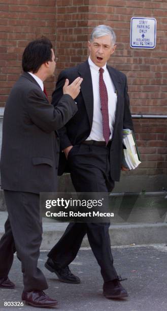 Jonathan Benedict, right, the prosecutor in the Moxley murder case, talks to an unidentified man outside the Stamford, Connecticut courthouse, April...