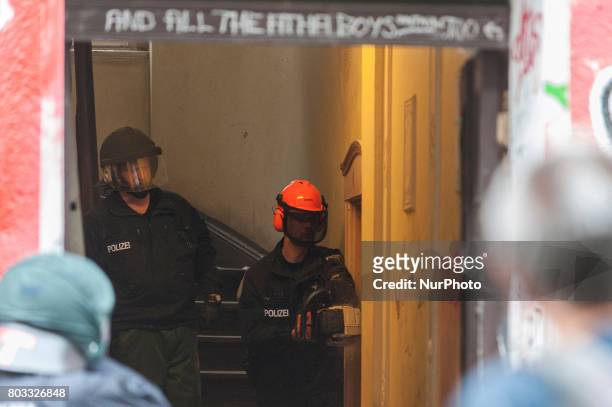 Riot policeman tries to gain access to the shop with a chain saw in Berlin, Germany on 29 June 2017. The shop in the district Neuklln was terminated...