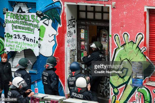 Riot policeman breaks the entrance door to the house in Berlin, Germany on 29 June 2017. The shop in the district Neuklln was terminated in April...