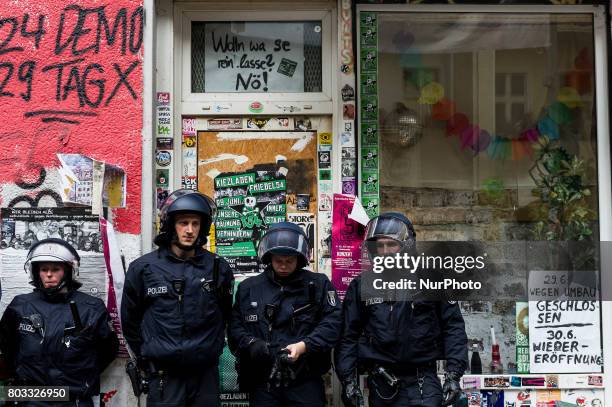 Riot policemen stand under a poster with writing &quot;Should we let them in? No!&quot; in Berlin, Germany on 29 June 2017. The shop in the district...