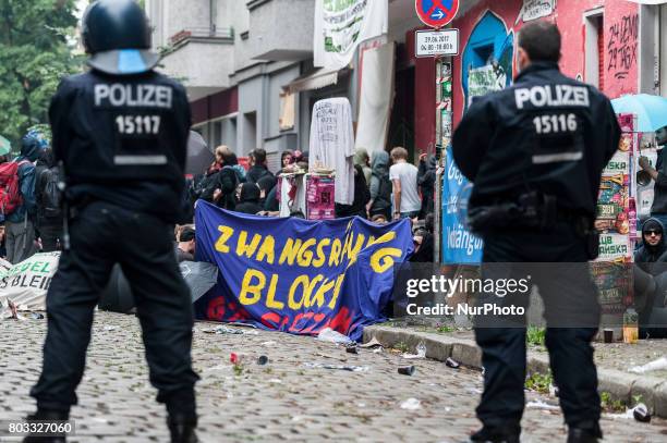 Riot policemen observe the people who block the entrance in the shop in Berlin, Germany on 29 June 2017. The shop in the district Neuklln was...