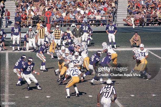 Quarterback John Hadl of the San Diego Chargers hands off to running back Jeff Queen against the Minnesota Vikings at San Diego Stadium pn December...