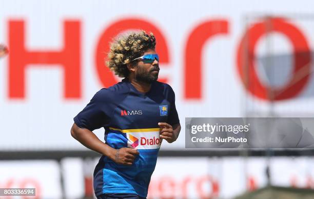 Sri Lankan cricketer Lasith Malinga loses his hat in the wind during a practice session ahead of the st ODI cricket match against the visiting...
