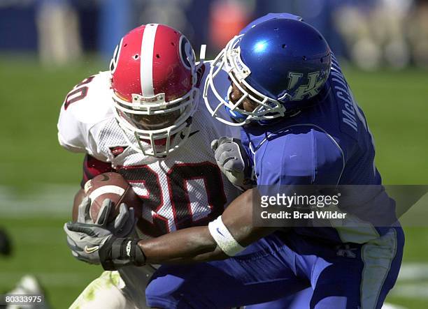 Georgia running back Thomas Brown is tackled by Kentucky's Marcus McClinton Saturday, November 6, 2004 at Commonwealth Stadium in Lexington,...
