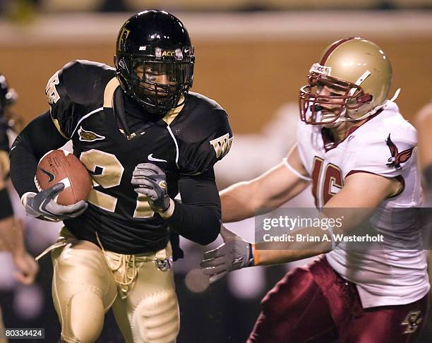 Wake Forest running back Kenneth Moore tries to avoid Boston College linebacker Brian Toal during first half action at Groves Stadium in...