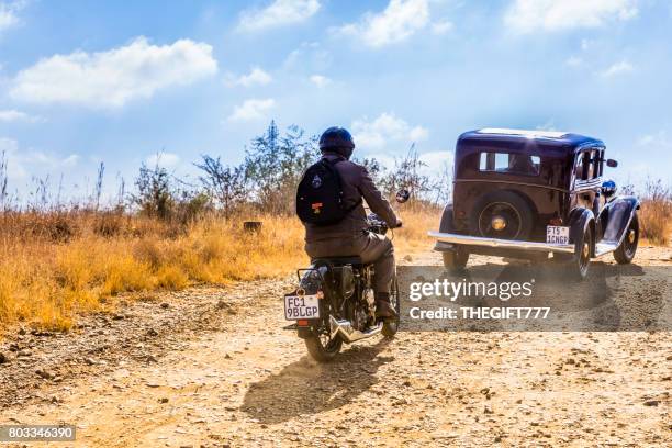 vintage buick followed by motorcycle at a show in magaliesberg - car exhibition stock pictures, royalty-free photos & images