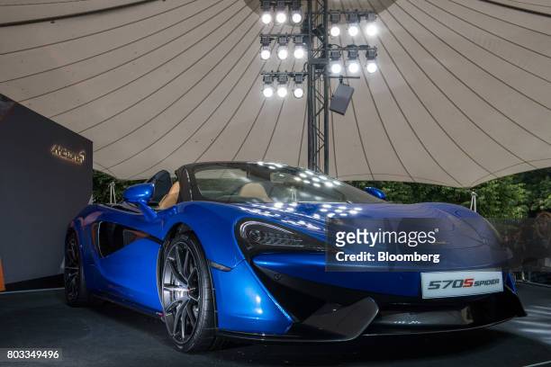 The McLaren 570S Spider automobile sits on a stand during its unveiling at the Goodwood Festival of Speed in Chichester, U.K., on Thursday, June 29,...