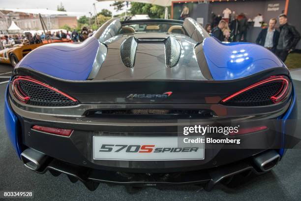 The McLaren 570S Spider automobile sits on a stand during its unveiling at the Goodwood Festival of Speed in Chichester, U.K., on Thursday, June 29,...