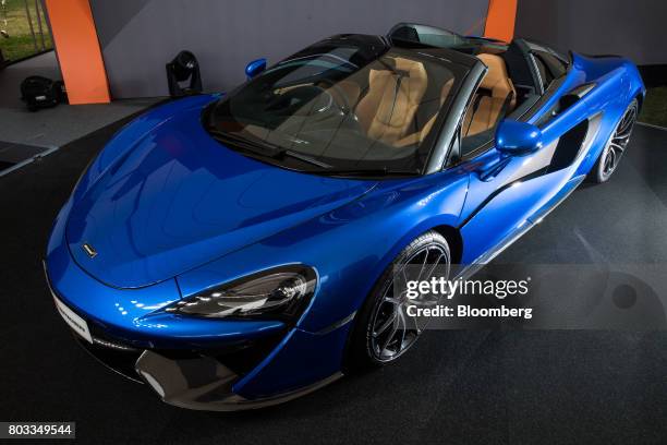 The McLaren 570S Spider automobile sits on a stand during its unveiling at the Goodwood Festival of Speed in Chichester, U.K., on Thursday, June 29,...