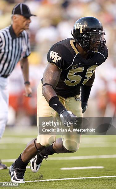 Wake Forest linebacker Aaron Curry looks to apply pressure to the Syracuse quarterback during first half action at Groves Stadium in Winston-Salem,...
