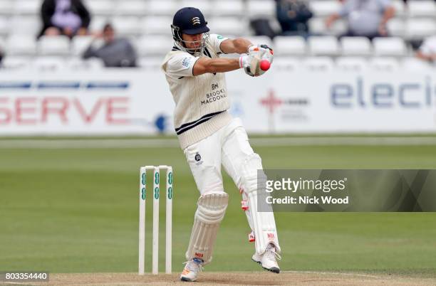 Nick Compton of Middlesex plays a rare attacking stroke during the Specsavers County Championship Division One match between Essex and Middlesex at...