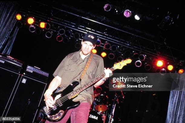 American Rock musician Henry Bogdan, of the group Helmet, plays bass guitar as he performs onstage during the LifeBeat Board Aid 2 benefit concert at...