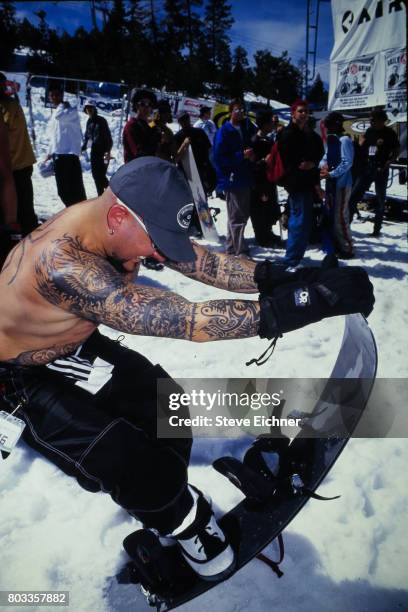 Portrait of American Rock musician Evan Seinfeld, of the group Biohazard, as he poses with a snowboard at the LifeBeat Board Aid 2 benefit at Big...