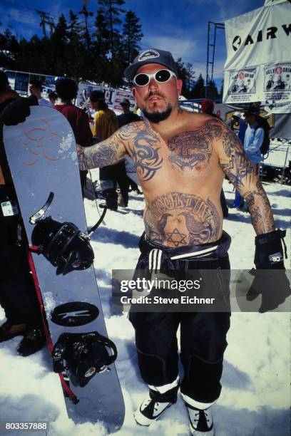 Portrait of American Rock musician Evan Seinfeld, of the group Biohazard, as he poses with a snowboard at the LifeBeat Board Aid 2 benefit at Big...