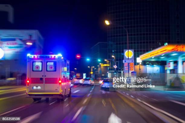 pov from the driving car in the night, wurzburg, bavaria, germany - ambulance lights stock pictures, royalty-free photos & images