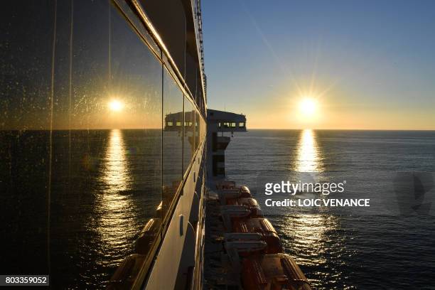 Picture taken on June 25, 2017 shows Cunard cruise liner RMS Queen Mary 2 sailing in the Atlantic ocean during The Bridge 2017, a transatlantic race...