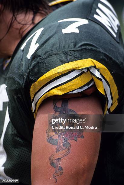 Tony Mandarich of the Green Bay Packers with his Guns 'n Roses tatoo during a game against the Miami Dolphins on September 22,1991 in Miami, Florida.