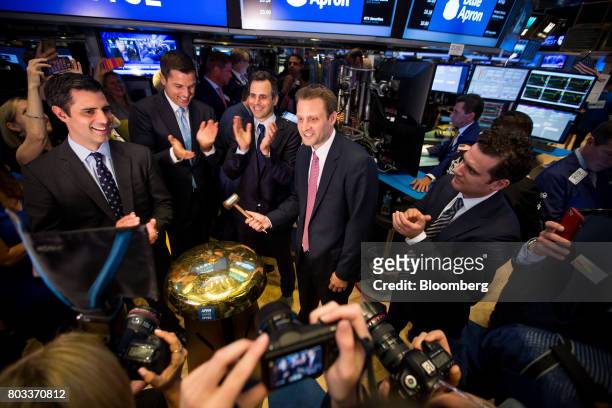 Matt Salzberg, co-founder and chief executive officer of Blue Apron Holdings Inc., center, rings a ceremonial bell with Ilia Papas, co-founder and...