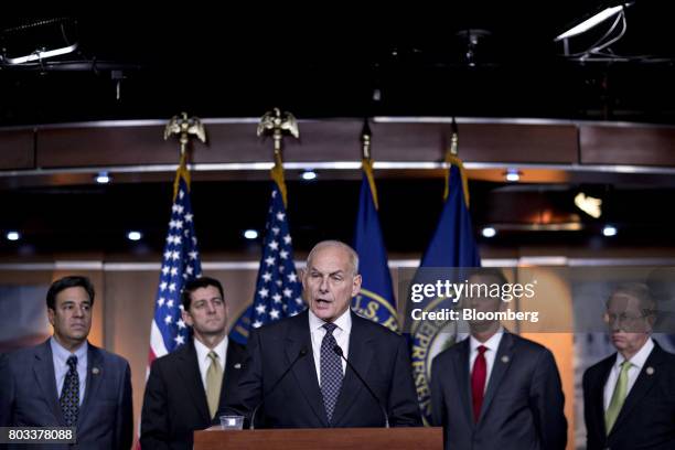 General John Kelly, U.S. Secretary of Homeland Security, center, speaks during a news conference with Representative Raul Labrador, a Republican from...