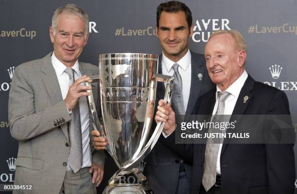 Tennis legend John McEnroe, Swiss player Roger Federer and Australian tennis legend Rod Laver pose with the Laver cup in Wimbledon, south west London...