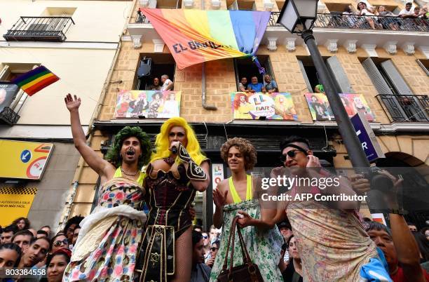Drag queen presents the three winners of the "High Heels Race" as part of the WorldPride 2017 celebrations in Madrid on June 29, 2017. The annual...