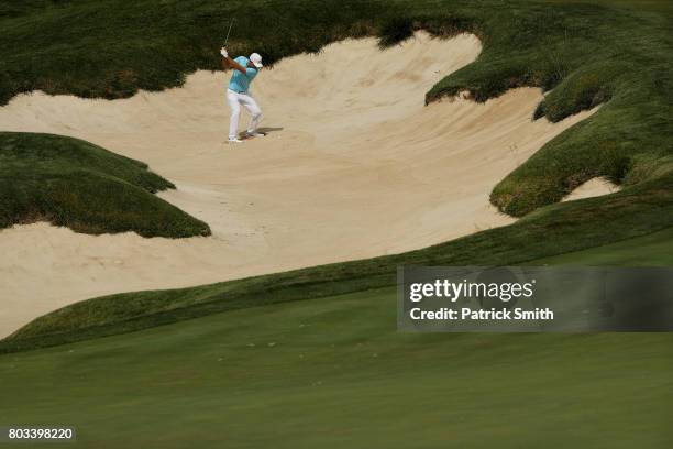 Russell Henley of the United States plays a shot from a bunker on the 18th hole during the first round of the Quicken Loans National on June 29, 2017...