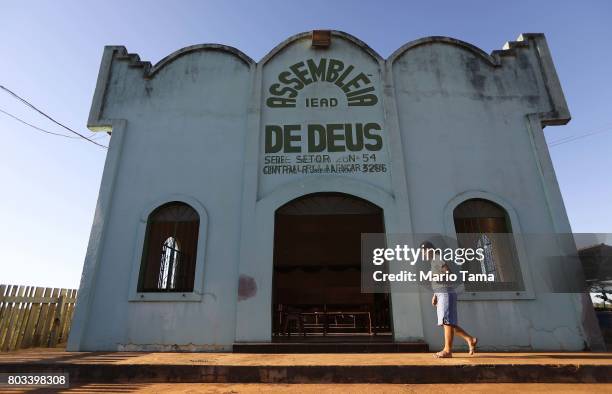 Woman walks before Sunday services at an evangelical church located in a partially deforested section of the Amazon rainforest on June 25, 2017 near...