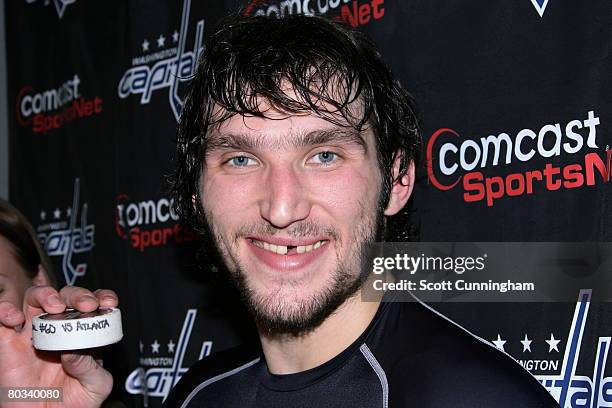 Alexander Ovechkin of the Washington Capitals poses with the puck used to score his 60th goal of the season against the Atlanta Thrashers at Philips...