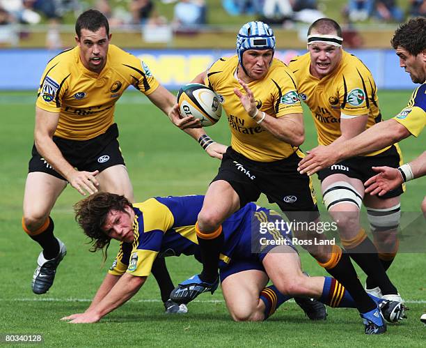 Matt Giteau of the Western Force busts through the Highlanders defence during the round six Super 14 match between the Highlanders and the Western...