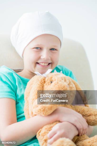 sick child holding toy - kids cancer smile stock pictures, royalty-free photos & images
