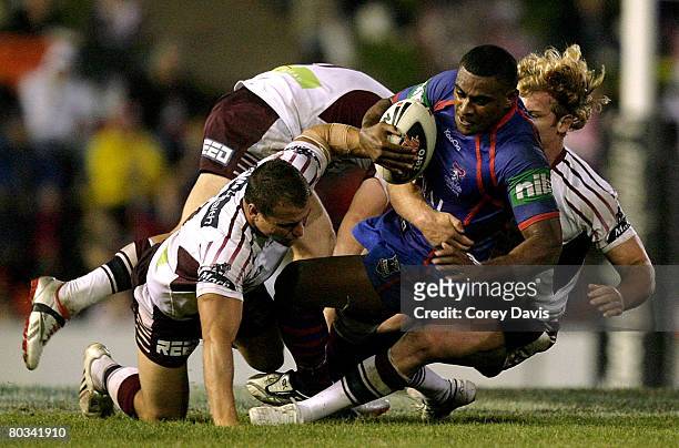 Wes Naiqama of the Knights is tackled during the round two NRL match between the Newcastle Knights and the Manly Warringah Sea Eagles at...