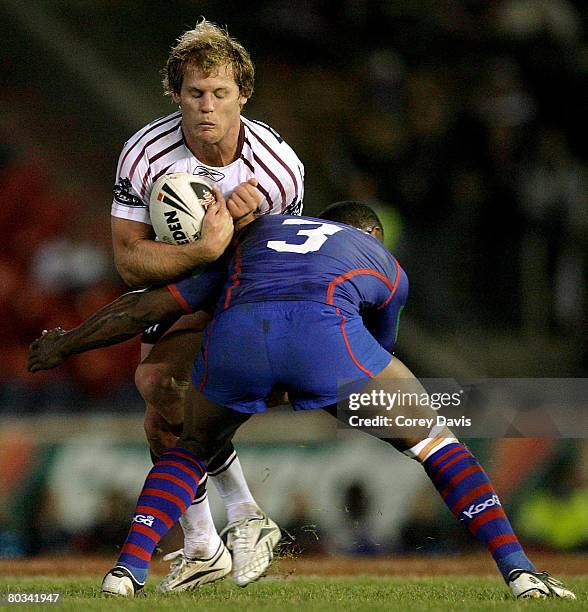 Luke Williamson of the Sea Eagles is tackled by Wes Naiqama of the Knights during the round two NRL match between the Newcastle Knights and the Manly...