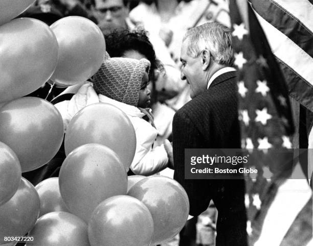 Presidential candidate Walter Mondale greets a child during a campaign rally at the Boston Common on Nov. 2, 1984.