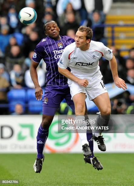 Manchester City's English defender Nedum Onuoha vies with Bolton Wanderers' English forward Kevin Davies during the English Premier league football...