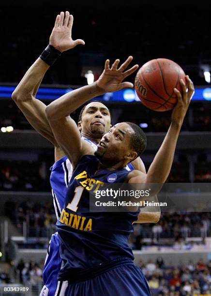 Gerald Henderson of the Duke Blue Devils goes up for the block against Da'Sean Butler of the West Virginia Mountaineers during the second round of...