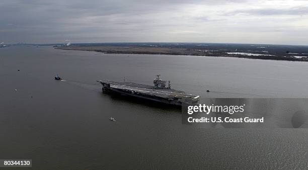 In this photo provided by the U.S. Coast Guard, the decommissioned aircraft carrier John F. Kennedy is towed to join other decommissioned ships at...