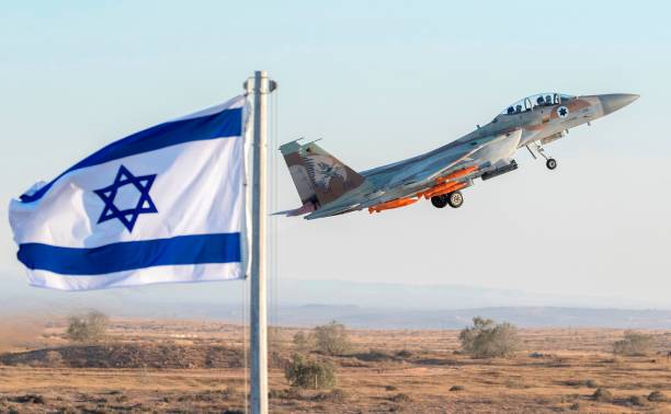 An Israeli Air Force F-15 Eagle fighter plane performs at an air show during the graduation of new cadet pilots at Hatzerim base in the Negev desert,...