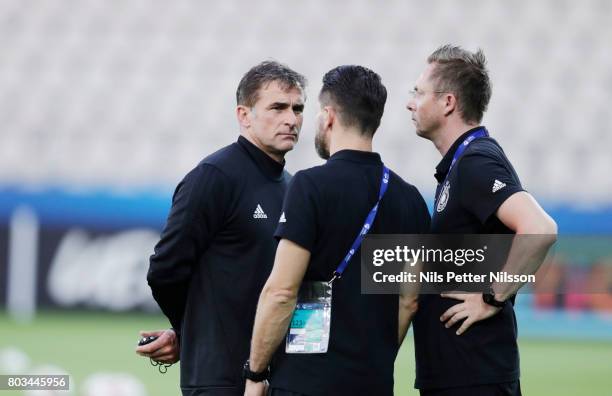 Stefan Kuntz, head coach of Germany in discussion with other leaders during the Germany U21 national team press conference at Krakow Stadium on June...