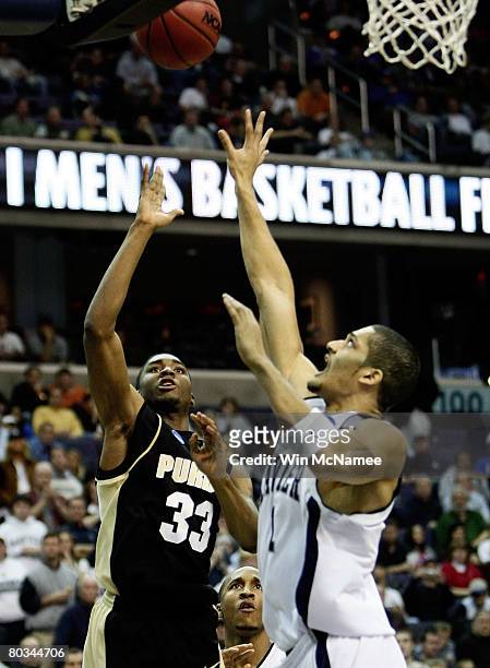 Twaun Moore of the Purdue Boilermakers shoots over Josh Duncan of the Xavier Musketeers during the second round of the West Regional as part of the...