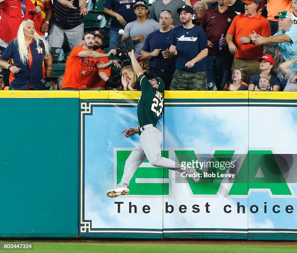 Matt Joyce of the Oakland Athletics makes a leaping catch at the wall on fly ball by Josh Reddick of the Houston Astros in the first inning at Minute...