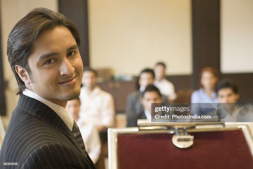 Portrait of a businessman at a lectern