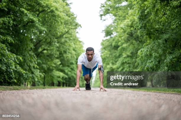 athletic man ready for running at the park - sprinting stock pictures, royalty-free photos & images
