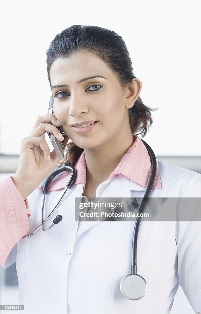 Portrait of a female doctor talking on a mobile phone