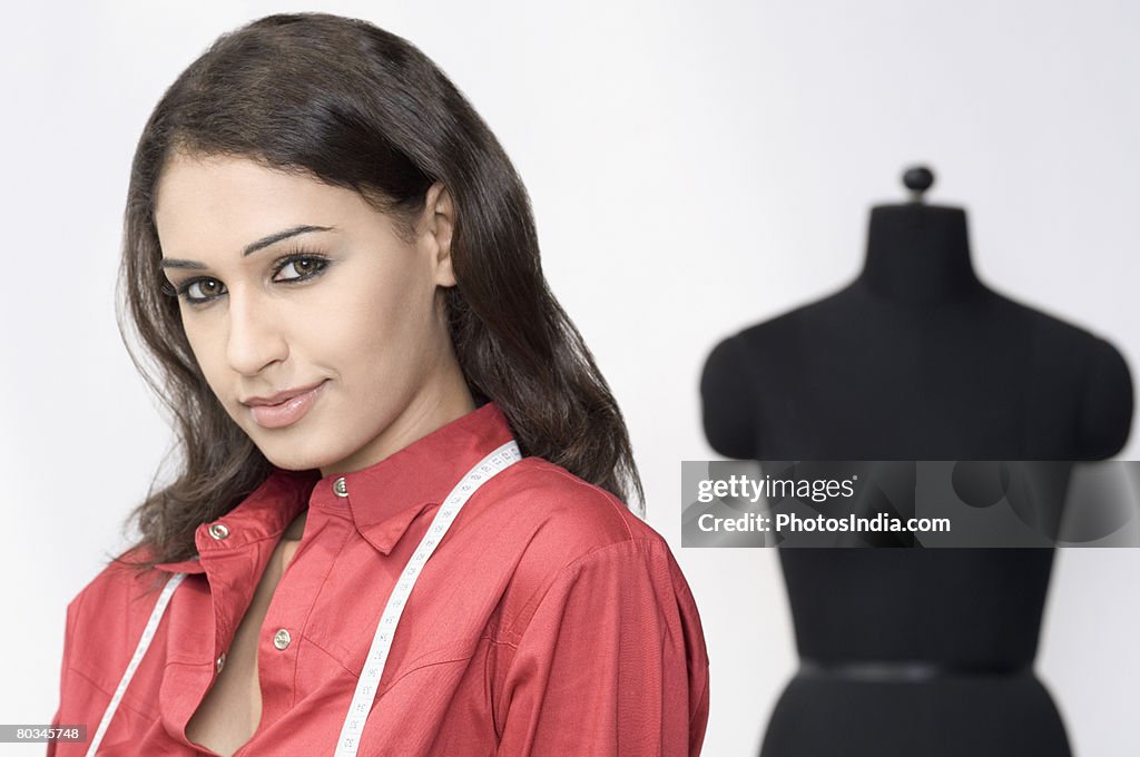 Portrait of a fashion designer with measuring tape around her neck