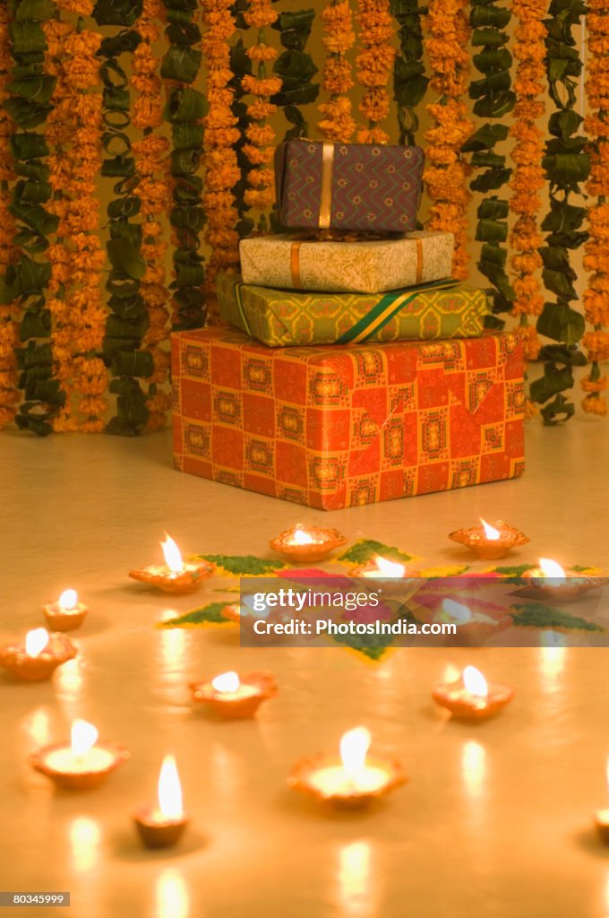 Stack of gifts near oil lamps